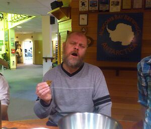 An expeditioner tasting some home made jerky at the bar.