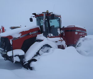 A quad track tractor after a heavy snowfall