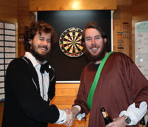 Shane Kern congratulated by Steve McInnerney after winning a darts match at Casey