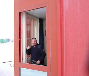Scott Clifford replacing a cracked window in the red shed