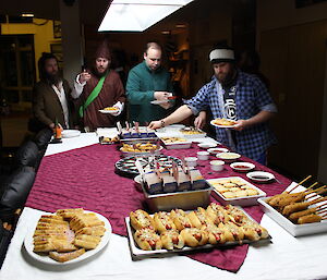 A buffett meal set out on top of the pool table at Casey