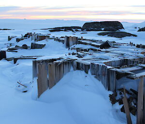 The old Wilkes station wooden buildings buried in ice and covered by fresh snow