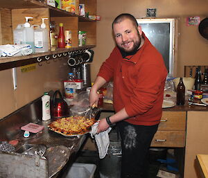 Scott Clifford serving a freshly made pizza at the Wilkes Hilton on the Clark Peninsula