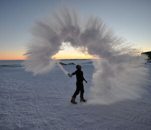 A spray of cloud forms as Pete Hargreaves throws a cup of boiling water into the air at minus 30 degress C at Casey 2014