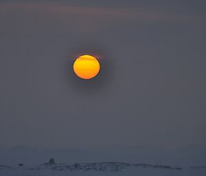 An orange sun through a filter of fog at Casey 2014