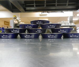 A pyramid of pies in their blue tins with Fray Bentos written on the front