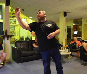 An expeditioner playing darts at Casey station, Antarctica