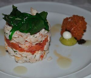Lobster with caviar, cucumber spaghetti and lemon gel on a white plate