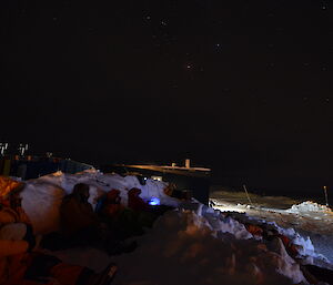 Expedtioners at Casey watching a movie outside in the winter 2014