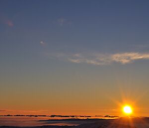 Clear skies with a setting sun just on the horizon