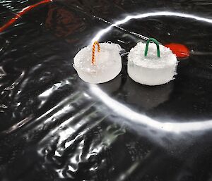 Ice curling stones on the marked polythene sheet laid down in the Workshop at Casey for the Midwinter games 2014