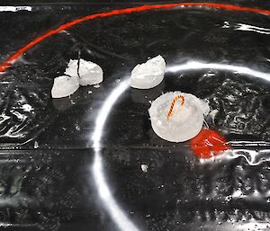 Broken ice curling stones on a marked polythene course at Casey Midwinter 2014