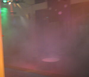 The 9th hole in the indoor golf tournament at Casey is obsuced by smoke and lights — Casey winter 2014