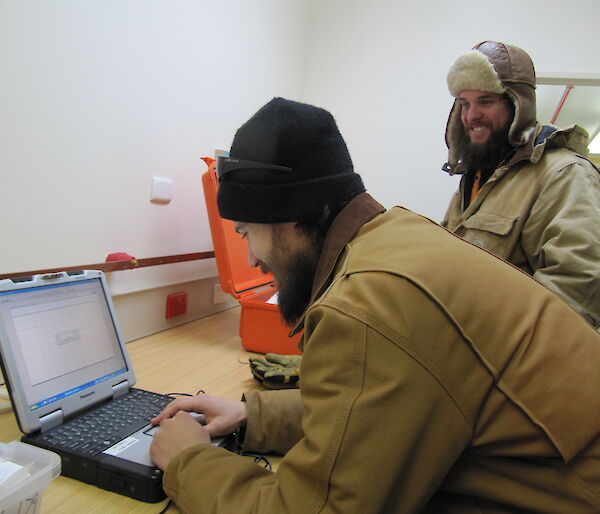 Expeditioners prepare scientific equipment prior to field deployment
