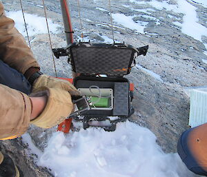 An expeditioner sets up the replacement data logger
