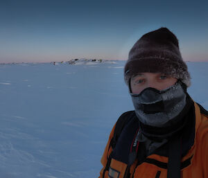 Portrait of an expeditioner with only their eyes showing, taken outside in Antarctica