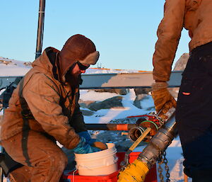 Matt Melhuish preparing the refulling hose connection nicknamed ‘pig’ for insertion in the hose to clear the line of fuel during refuelling