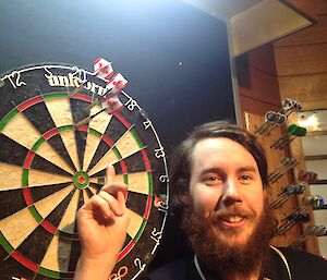 Steve McInnerney next to the dart board at Casey with the top scoring throw of the interstation darts match with Mawson