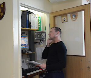 An expeditioner writing poetry in the closet at Casey station.