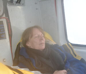 An expeditioner asleep in a Hägglunds vehicle, en route to Brownings hut