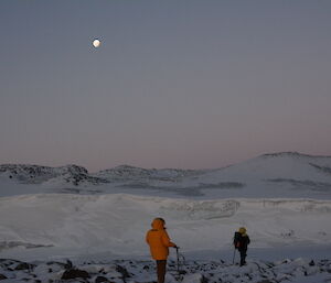 A view across the frozen ocean to the moonrise above the white peninsula