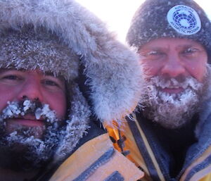Expeditioners take photos of their ice covered beards at the Antarctic circle