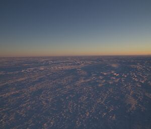 A view across the frozen Antarctic plateau during dusk at the site of the Antarctic circle, near Casey station.