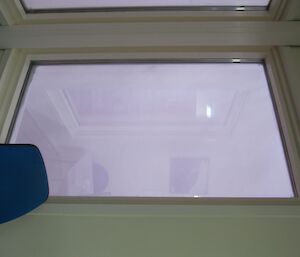 A view of snow flying past the window creating the illusion of a solid white wall outside the window at Casey during a blizzard winter 2014