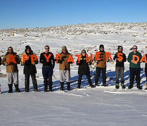 Casey expeditioners hold letters that spell Happy Father’s Day on Sunday the 7th September 2014