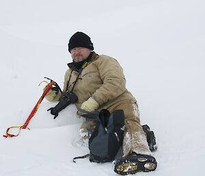 Rob Bennett lying on the sea ice watching seals at Caseu August 2014