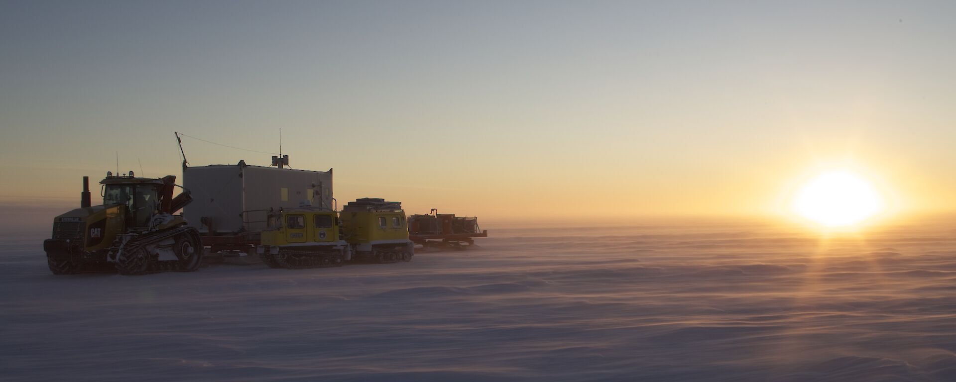 A beautiful golden sunrise over the ice on the final morning of the traverse