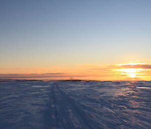 Another golden sunset over Casey station, as the traverse group heads down the hill on their return