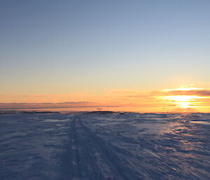 Another golden sunset over Casey station, as the traverse group heads down the hill on their return