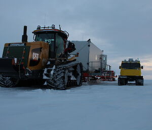 A photo indicating the immense size of the Challenger tractor alongside a Hägglunds vehicle.