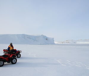 Expeditioners stop their quad bikes near the edge of the sea ice at Shirley Island