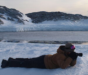 Stu Griggs photographing seals on the sea ice at Casey September 2014