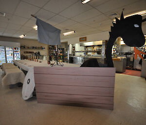 Dining table at Casey set up like a Viking ship with a dragon figurehead