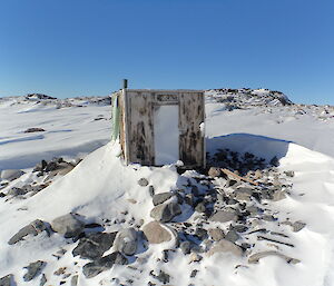 An old snow-filled hut near the Whitney Point Adélie penguin colony
