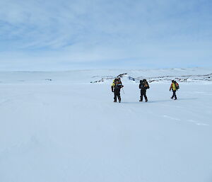 Expeditioners walking back to the Hägglunds over the sea ice from Blakeney Point