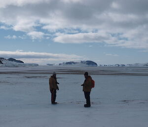 Steve Hankins and Scott Clifford looking out over the sea ice towards Petersons Island