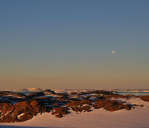Browning Peninsula landscape at twilight with moon in distant sky