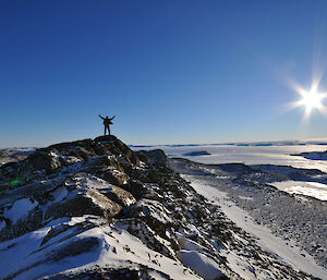 Rob Bennett on a hilltop with arms outstretched at Browning Peninsula