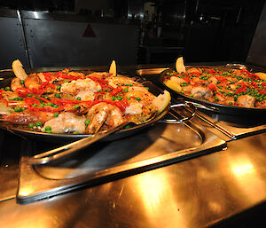 Paella on trays under the heat lamps on the Bain Maire at Casey