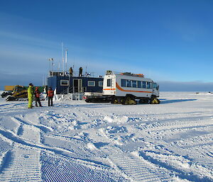 The Casey winterers at the skiway offices with vehicles ready to take the planes passengers back to the station