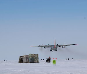 A C-130 leaves Casey skiway, with it’s cargo of equipment in the foreground