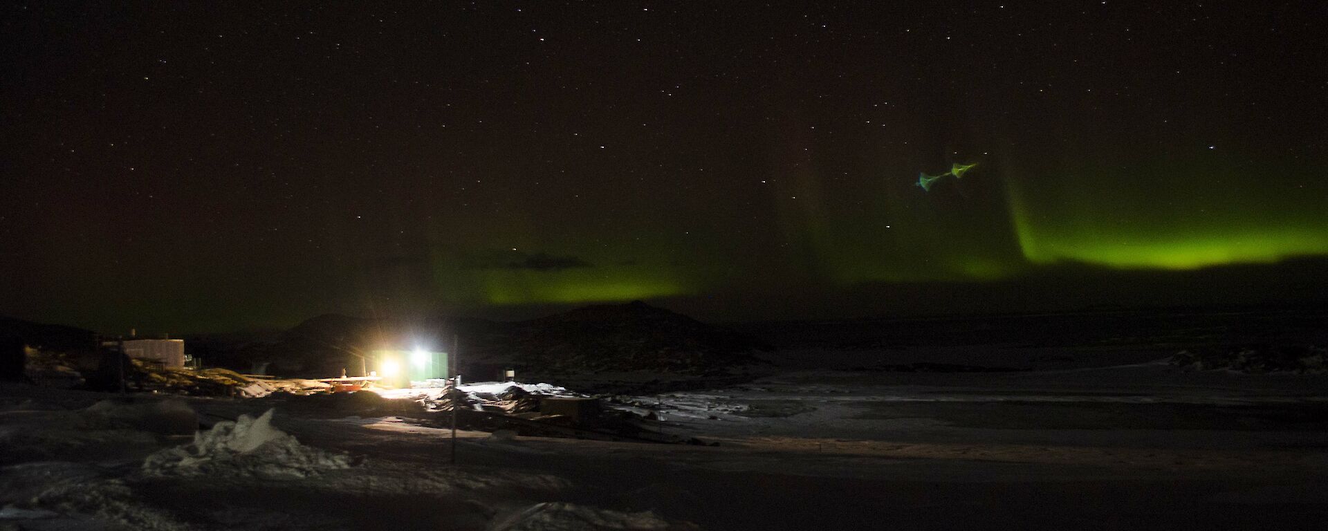 A lens flare type of aberration in a photo of an Aurora above Casey station