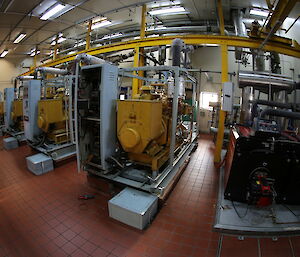 The engine room of the main power house. Rows of large diesel engines.
