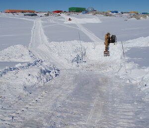 The wharf road excavation in process, with dozer and excavator removing many thousands of tonnes of snow