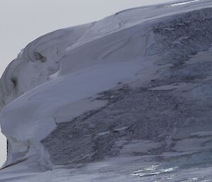 Swirled ice cliff formations with inlaid dirt on the way to Peterson island