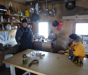 Two expeditioners enjoy a cup of tea in the Wilkes Hilton.